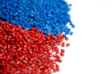 Blue and red plastic polymer granules isolated on white 