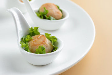 Scallop snack on spoon