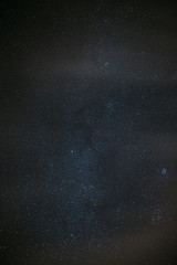 Milky Way Galaxy Glowing Through The Light Cloudiness Overcast. Real Night Sky Stars. Natural Starry Sky Dark Black Background Backdrop