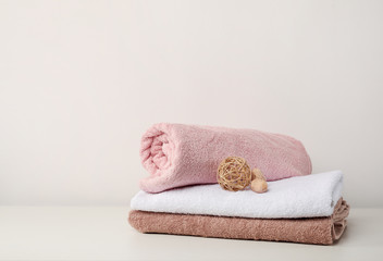 Fototapeta na wymiar Stack of bath towels with bamboo balls on white background