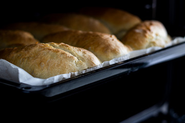 making bread at home. baking dough in oven. front view. food concept. homemade