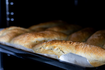 making bread at home. baking dough in oven. front view. food concept. homemade