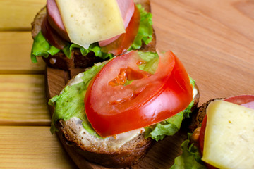 homemade sandwich with vegetables, sausage and cheese