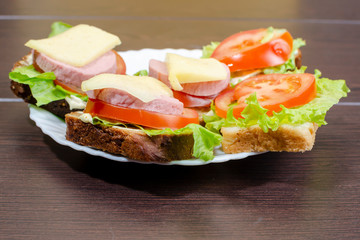 fresh sandwiches with vegetables, meat and cheese