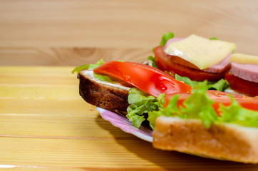 fresh sandwiches with vegetables, meat and cheese close-up