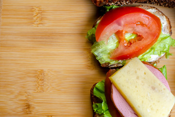 fresh sandwiches on a light wooden background