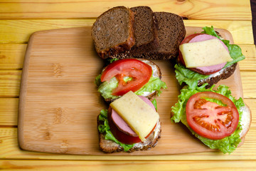 fresh sandwiches on a light wooden background