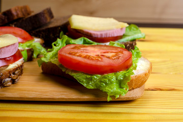 fresh sandwiches on a light wooden background
