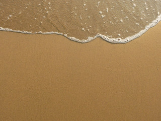 Fototapeta na wymiar soft wave of the sea on sand beach