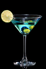 cocktail with martini, olives and lime wedge