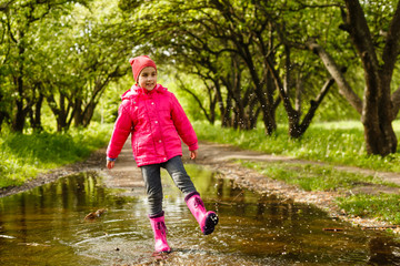 little girl riding bike in water puddle