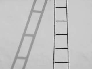 Bamboo stair on white wall with shadow in construction site