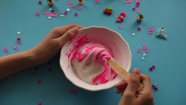 Photo instruction step by step how to make slime at home, kids hands making slime toy on blue background