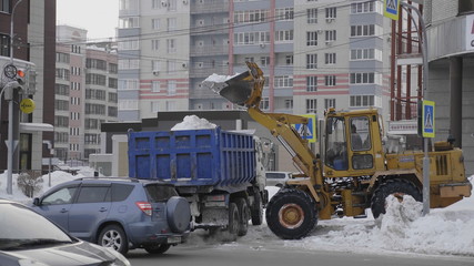 MOSCOW - December 20: small tractor scraper collects snow on December 20, 2019 in Moscow, Russia.