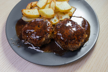 Hamburger steak covered in red wine sauce.