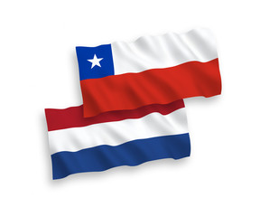 National vector fabric wave flags of Chile and Netherlands isolated on white background. 1 to 2 proportion.