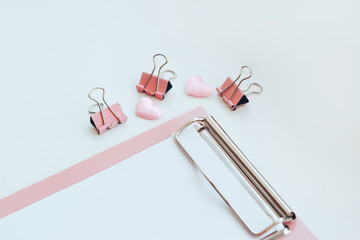 Tablet file folder in pastel pink colors and office accessory on white backdrop