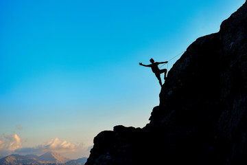 the struggle and success of the rock climbing man