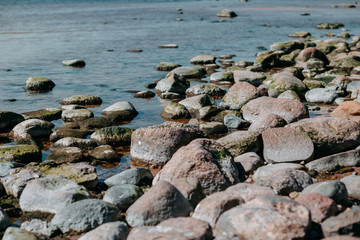 Ocean shore, sand and rocks on the sea coast.