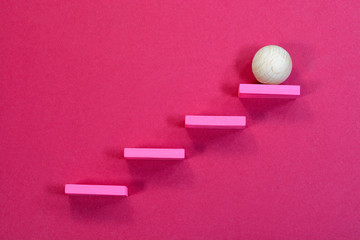 Leadership ball climbing the steps to the top