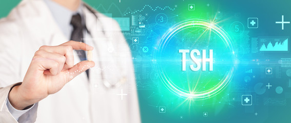 Close-up of a doctor giving you a pill with TSH abbreviation, virology concept