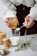 Pouring honey to milk