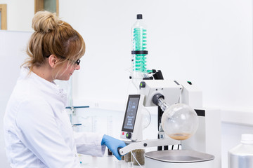 Chemist extracting cbd with rotavapor in laboratory