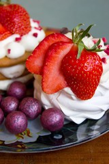 Appetizing cakes with strawberries and round candies