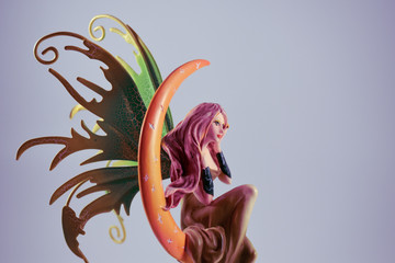 Detail of the statue of a fairy sitting on the moon