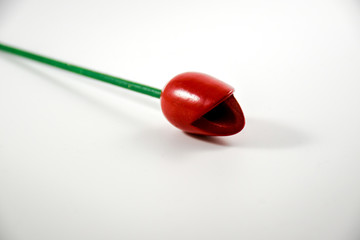 Still life with a red wooden tulip with a white background