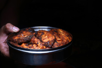 Homemade deeply fried fish in a steel bowl with dark background, delicious fish fry