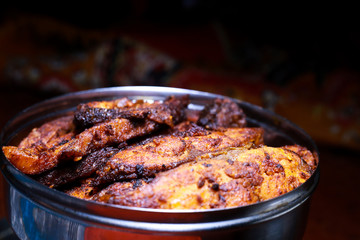 Homemade deeply fried fish in a steel bowl with dark background, delicious fish fry