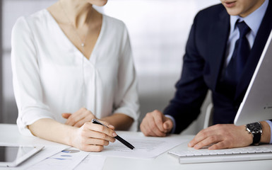 Unknown businessman and woman discussing contract in office. closeup.Business people or lawyers working together at meeting. Teamwork and partnership