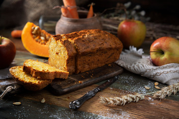 
Pumpkin muffins and apples on a wooden table