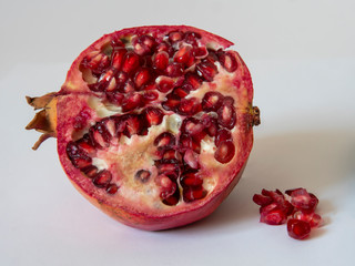 fresh pomegranate with seeds on white background