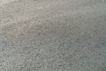 Seamless tarmac dark grey grainy road. Texture background