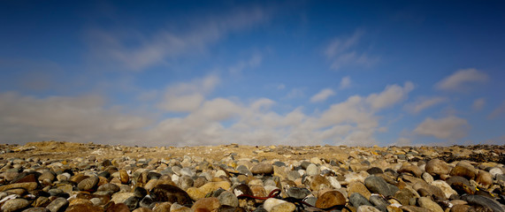 long exposure image of rocks,sea, clouds