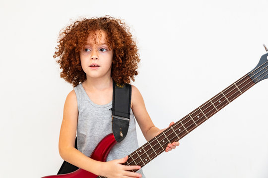 Brazilian And Caucasian Girl With Curly Hair, Happy Child Playing Guitar, Double Bass, Musical Instrument