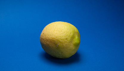 ripe yellow lemon, and blue background