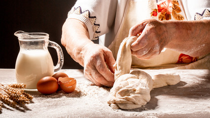 old woman, grandmother hands with flour splash. Cooking bread slams ball dough on white powder...