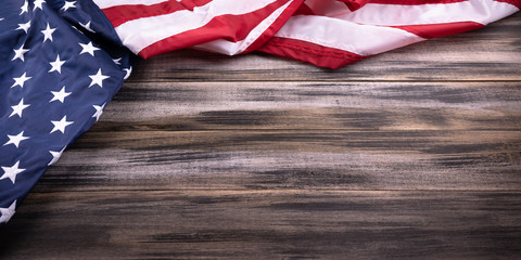 Red, white, and blue American flag on wood background for Memorial day, 4th of July, Flag Day  , Veteran's day, or Independence Day. Holiday concept.