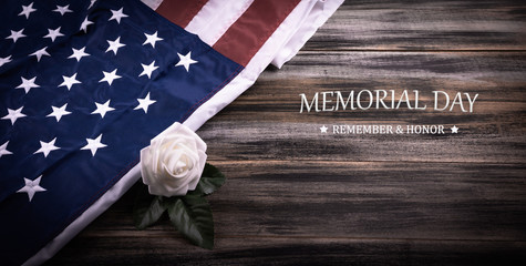 Vintage red, white, and blue American flag   with white rose and Text MEMORIAL DAY on a wood background. - obrazy, fototapety, plakaty