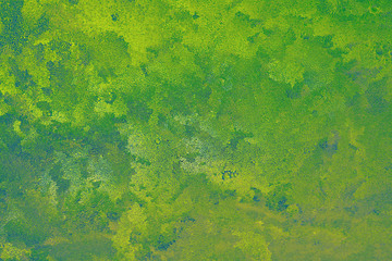 Fototapeta na wymiar Abstract spotted green yellow and slightly blue background. Chaotic spots and stains, like watercolor strokes or frost on a window. Vibrant color background or wallpaper