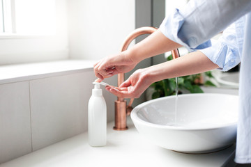 Woman washing and lathering hands. Liquid antibacterial soap and foam. Infection prevention. Self...