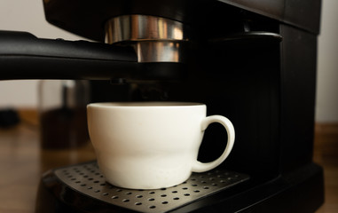 White cup in a coffee machine