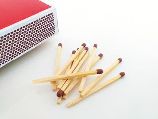Aerial view of Piles of brown matchstick isolated on white with Matchbox. Wooden rods with a flammable head used to light a fire.