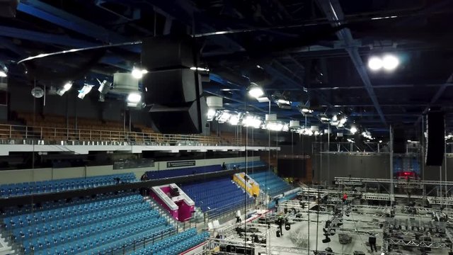 Aerial of professional lighting equipment for concert stage. Stock footage. Installation of professional sound, light, video and stage equipment for a concert.