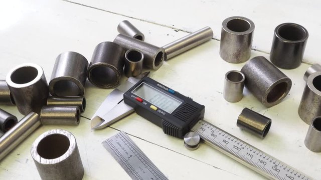 Engineer work. Measurement of the metal part of driving chain  with a caliper