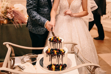 bride and groom cut a wedding cake