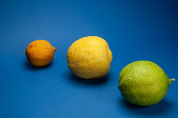 orange green lemon, composition with blue background